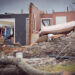 photograph of a house destroyed by a tornado on March 31, 2023 in Little Rock, Arkansas. in this image the walls and roof of the house are gone, and the contents of the rooms can be seen