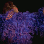 Color photograph taken by Chris Attig Blue Bus Photos showing Arkansas Drag Queen Jazmyn Turrelle Foster performing drag in her evening gown during the talent portion of the 2023 Miss Gay Central Arkansas America Drag Pageant in Conway, Arkansas.