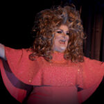 Color photograph of arkansas drag queen miss gay arkansas america 1992 missy klein performing in sequined red dress