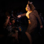 Color photograph taken by Chris Attig Blue Bus Photos showing Arkansas Drag Queen Savvy Savant performing during an intermission at the 2023 Miss Gay Central Arkansas America Drag Pageant in Conway, Arkansas.