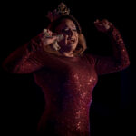 Color photograph taken by Chris Attig Blue Bus Photos showing Arkansas Drag Queen Savvy Savant performing during an intermission at the 2023 Miss Gay Central Arkansas America Drag Pageant in Conway, Arkansas.