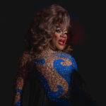 Color photograph taken by Chris Attig Blue Bus Photos showing Arkansas Drag Queen Jazmyn Turrelle Foster performing drag in her evening gown during the talent portion of the 2023 Miss Gay Central Arkansas America Drag Pageant in Conway, Arkansas.