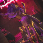 color image of of Little Rock Arkansas Drag Queen Devi Diamond performing at Diamonds and Pearls at Club Sway while dancing and collecting tips from the audience