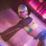 color image of Little Rock Arkansas Drag go go dancer performing at intermission of Diamonds and Pearls at Club Sway in a yellow skirt and top