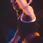 color image of Little Rock Arkansas Drag go go dancer performing at intermission of Diamonds and Pearls at Club Sway in a yellow skirt and top