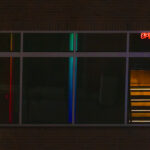 Window and night refliecting dark and minimalist neon light of streets of Little Rock Arkansas taken by Gynger a queer photographer from Little Rock Arkansas
