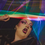 Image of Drag Artist Rosetta stoned appearing to throw a rainbow of light shaped like a lightning bolt from Little Rock Arkansas known as America's Capitol of Drag taken by Little Rock Arkansas Queer Photographer Gynger