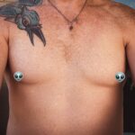 Little Rock Arkansas Trans woman and queer photographer Gynger St Claire takes a selfie showing her chest as estrogen starts to round out the shape of her breasts
